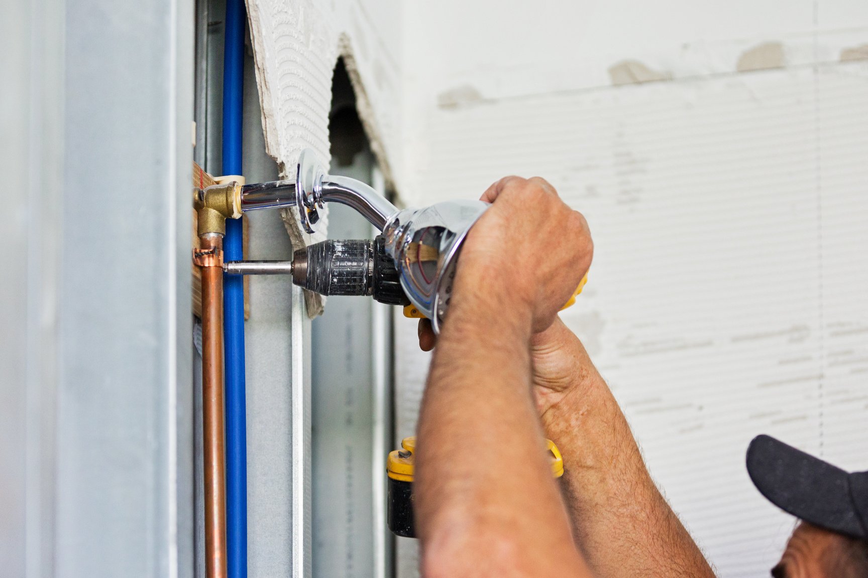 Plumber installing plumbing for shower